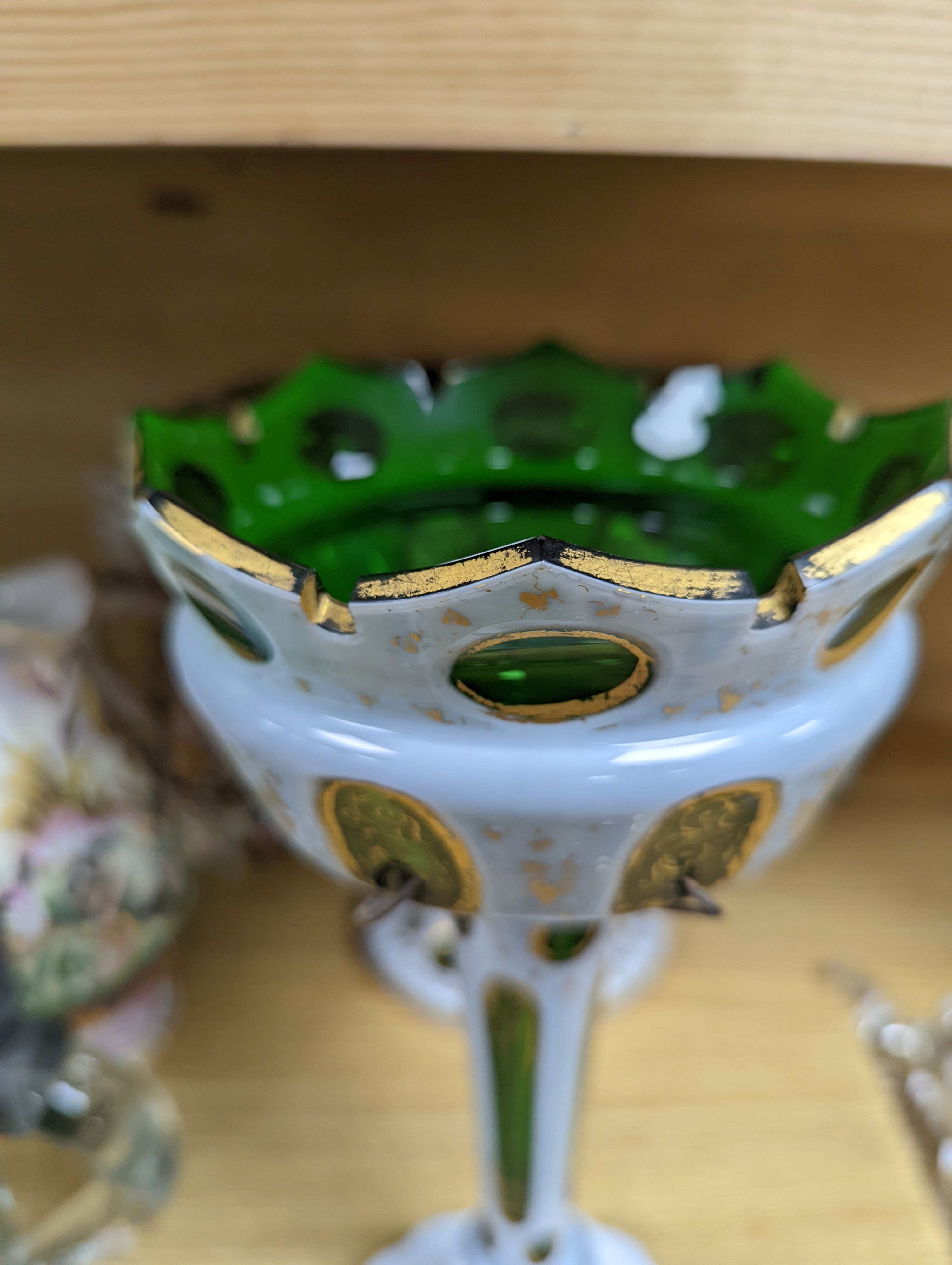 A 19th century overlaid green glass comport, 24cm high, and a similar table lustre